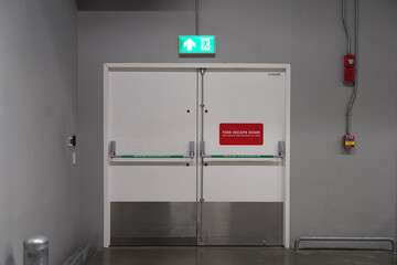 Fire extinguishers and fire escape door in building
