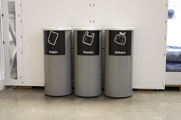 Trash cans with signs to classify waste types