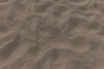 Beach sand abstract pattern footprints after rain nature texture background desert backdrop surface
