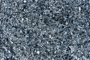 Closeup twisted spiral steel or aluminum metal shavings and cutting, industrial material recycle concept.