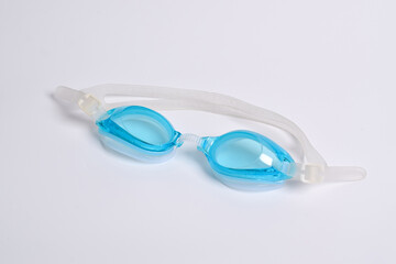Blue goggles for swimming on white background