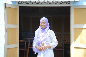 Portrait of young Asian woman wearing hijab posing.