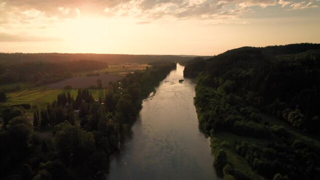 Aerial Floating Over Calm River in the Country at Sunset