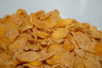 Close-up of corn flakes cereal on a white bowl