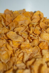 Close-up of corn flakes cereal on a white bowl