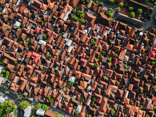 Aerial photography from a drone, tiled roofs of houses, dense buildings in a small settlement.
