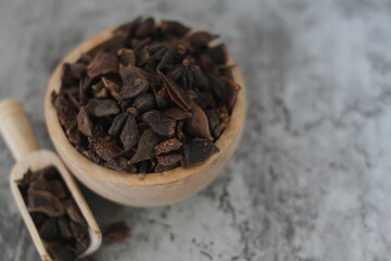 star anise in a wooden bowl on the table, close up