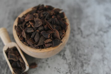 star anise in a wooden bowl on the table, close up