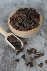 star anise in a wooden bowl on the table, close up