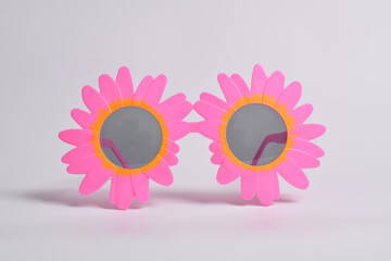 Party or birthday glasses in the shape of yellow sunflowers on a white background