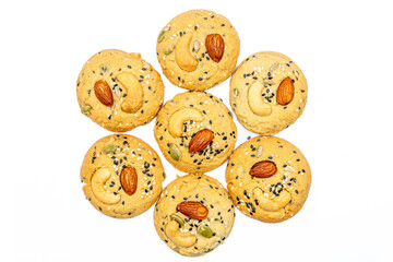 Isolated Healthy Whole Grain Cookies with different seeds, cashew nuts, almond, black sesame, pumpkin seed on white background