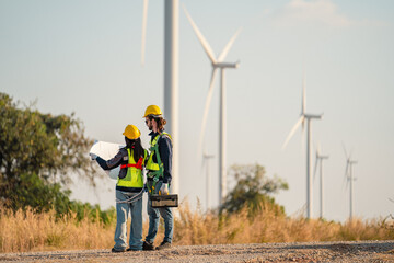 Engineers are working with wind turbines, Green ecological power energy generation, and sustainable windmill field farms. Alternative renewable energy for clean energy concept. - 771911482