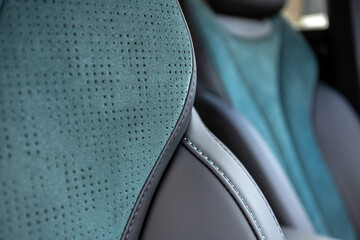 Part of leather car headrest seat details. Сlose-up blue and black   perforated leather car seat....