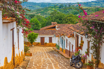 Charming street in Barichara, Santander, Colombia with colonial architecture and vibrant flowers