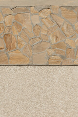 House building facade exterior with stone texture abstract pattern and beige stucco plaster wall background home