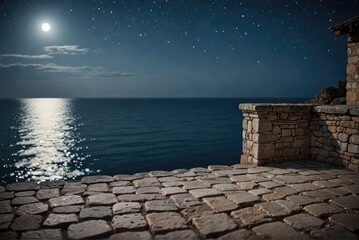 Rustic stone terrace offers a serene view of the moonlit seascape under a clear, starry night sky