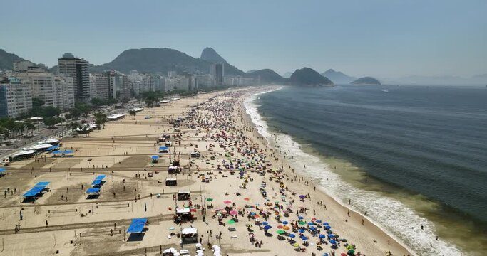 Aerial above Copacabana Beach  and people enjoying the sun by the ocean, Rio de Janeiro, Brazil