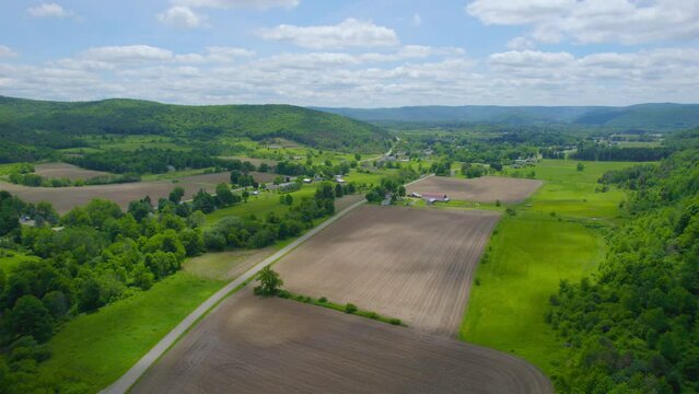 Flying over the countryside during the middle of summer.