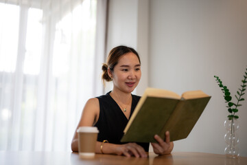Naklejka premium Businesswoman Reading Book in Peaceful Office Setting