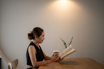 Contemplative Woman Enjoying Book in Minimalist Cafe