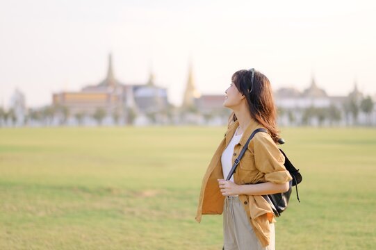 A Traveler Asian woman in her 30s exploring Wat Pra Kaew. From stunning architecture to friendly locals, she cherishes every moment, capturing it all in her heart and camera for years to come.