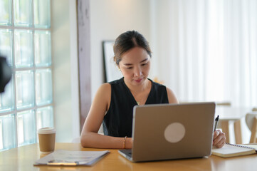 Focused Entrepreneur Working on Laptop with Coffee