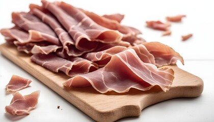 Pieces of dried pork prosciutto on a wooden board. white background