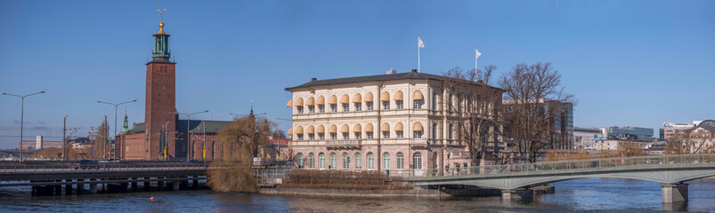 Panorama. The Town City Hall, an old yellow office building in the island Strömsborg, bridges and central train station in Stockholm a sunny spring day