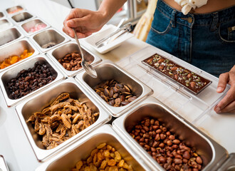Young woman in the workshop during a lesson on making handmade chocolates and sweets
