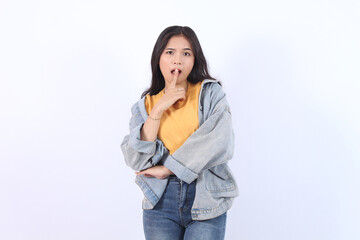 Photo of young Asian woman of Asian ethnicity 20s say hush be quiet with finger on lips shhh gesture isolated on white background studio portrait.
