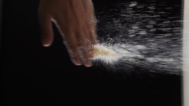 Slow motion shoot of sifting wheal flour with hands