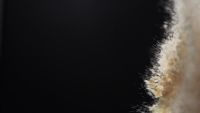 Bouncing white powder in the air against black background