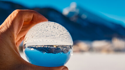 Crystal ball alpine winter landscape shot at Tannheim, Reutte, Tyrol, Austria