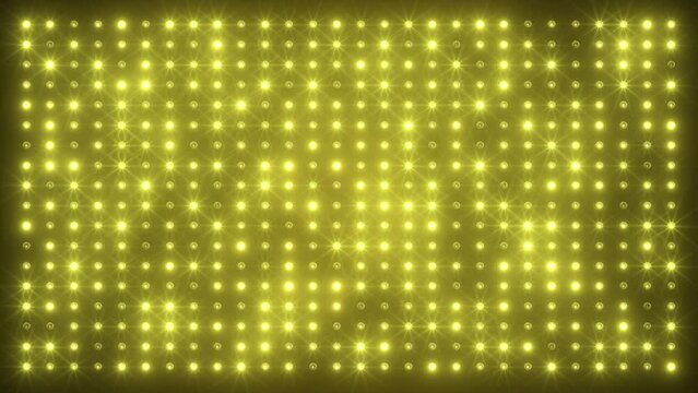 Video animation of an abstract glowing yellow, orange LED wall with bright light bulbs - abstract background.