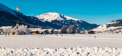 Alpine winter wonderland view with a hot air balloon near Tannheim, Reutte, Tyrol, Austria
