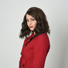 head and shoulders close up portrait of beautiful brunette woman model, wearing red trench coat...