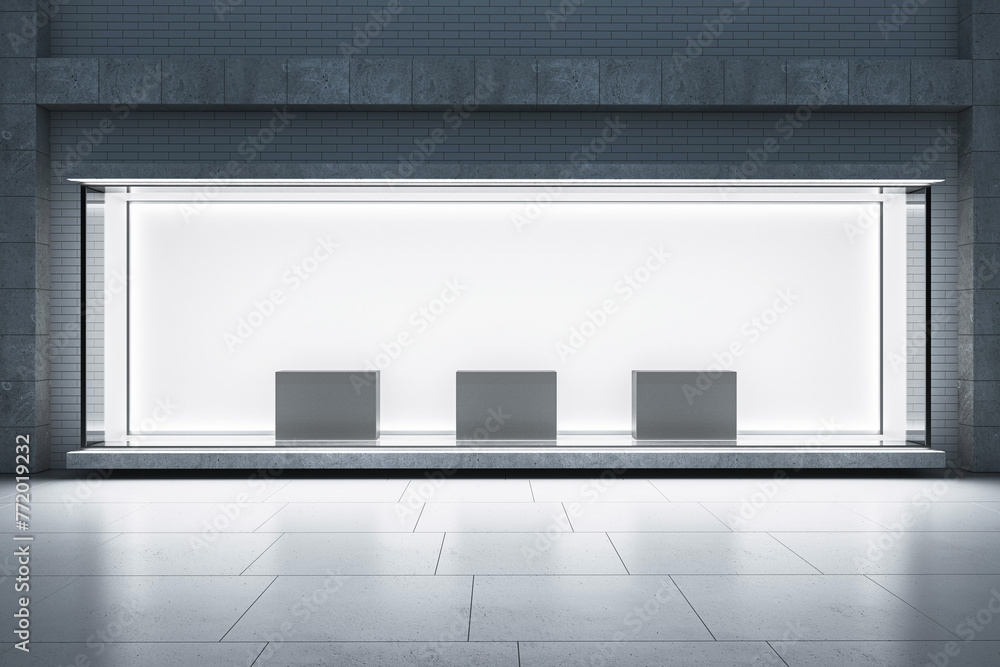 Poster An empty storefront with a large window display, backlit glass, and podiums for showcasing products against a brick wall, 3D Rendering. 3D Rendering