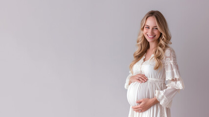 Blonde pregnant woman with pregnancy belly, in soft white clothes