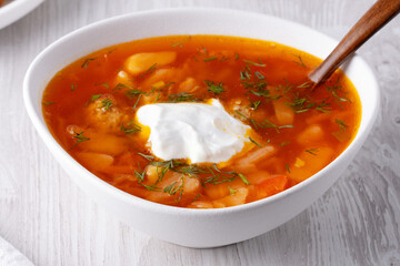Ukrainian and russian national red borsch with sour cream closeup