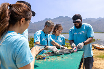 Team of ecologist volunteer pulling non biodegradable micro plastic from the endanger species fish...