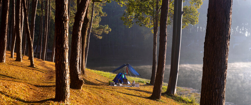Panorama single offgrid tent for overnight camping with sun light over misty mountain and ray of light and campsite of Pang Oung, Mae Hong Son, Thailand