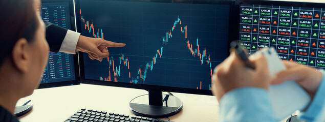 A cropped image of cooperate skilled business team discussion about stock investment while point the analysis stock chart. Show up and down trend. Stock market trading concept. Closeup. Burgeoning. - obrazy, fototapety, plakaty
