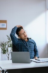 Male businessman is doing a stretchy posture due to sitting in the office for too long, office syndrome concept.