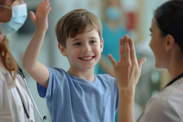 Happy cute little boy giving high five to pediatrician, friendly doctor greeting preschool patient...