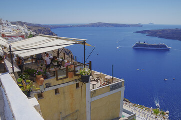 Modern luxury cruiseship cruise ship liner Equinox anchoring in caldera of Santorini Island with...