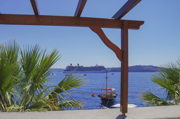 Modern luxury cruiseship cruise ship liner Equinox anchoring in caldera of Santorini Island with...