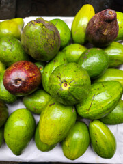 Close up of avocado fruits at street market. Top view. Fresh fruits and vegetables background up of avocado
