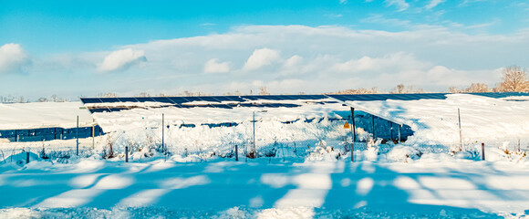 Winter wonderland view with a snow-covered photovoltaic system near Langenisarhofen, Deggendorf,...