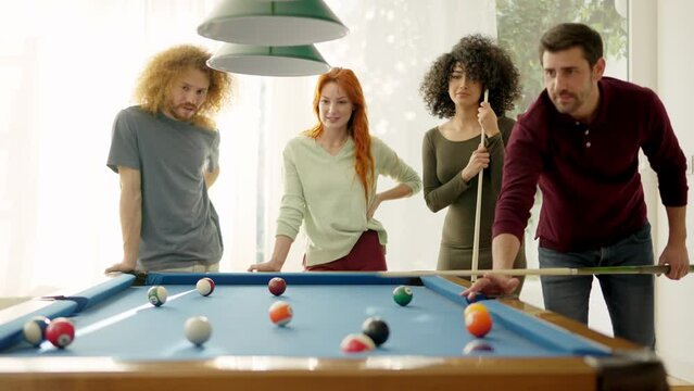 Friends having nice rivalry playing pool together at home