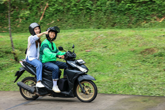 Asian Online Taxi Motorcycle Passenger Pointing a Place